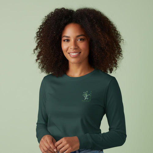 Teal long sleeve T-shirt worn by a model, with small Peace logo on chest