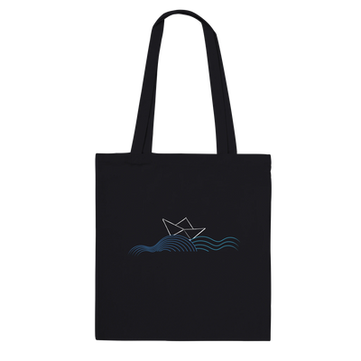 Black canvas tote bag with long handles and sailboat over wave graphic