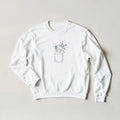 White unisex crewneck sweatshirt with small potted plant outline graphic on chest