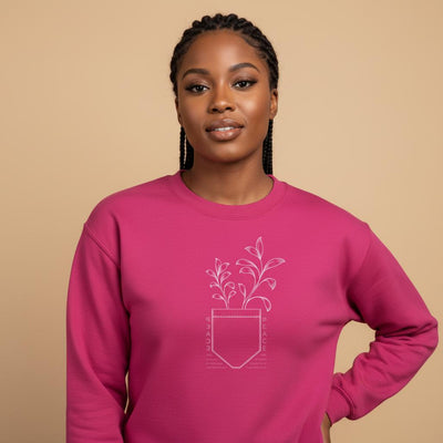 Unisex crewneck sweatshirt in magenta with potted plant graphic on chest
