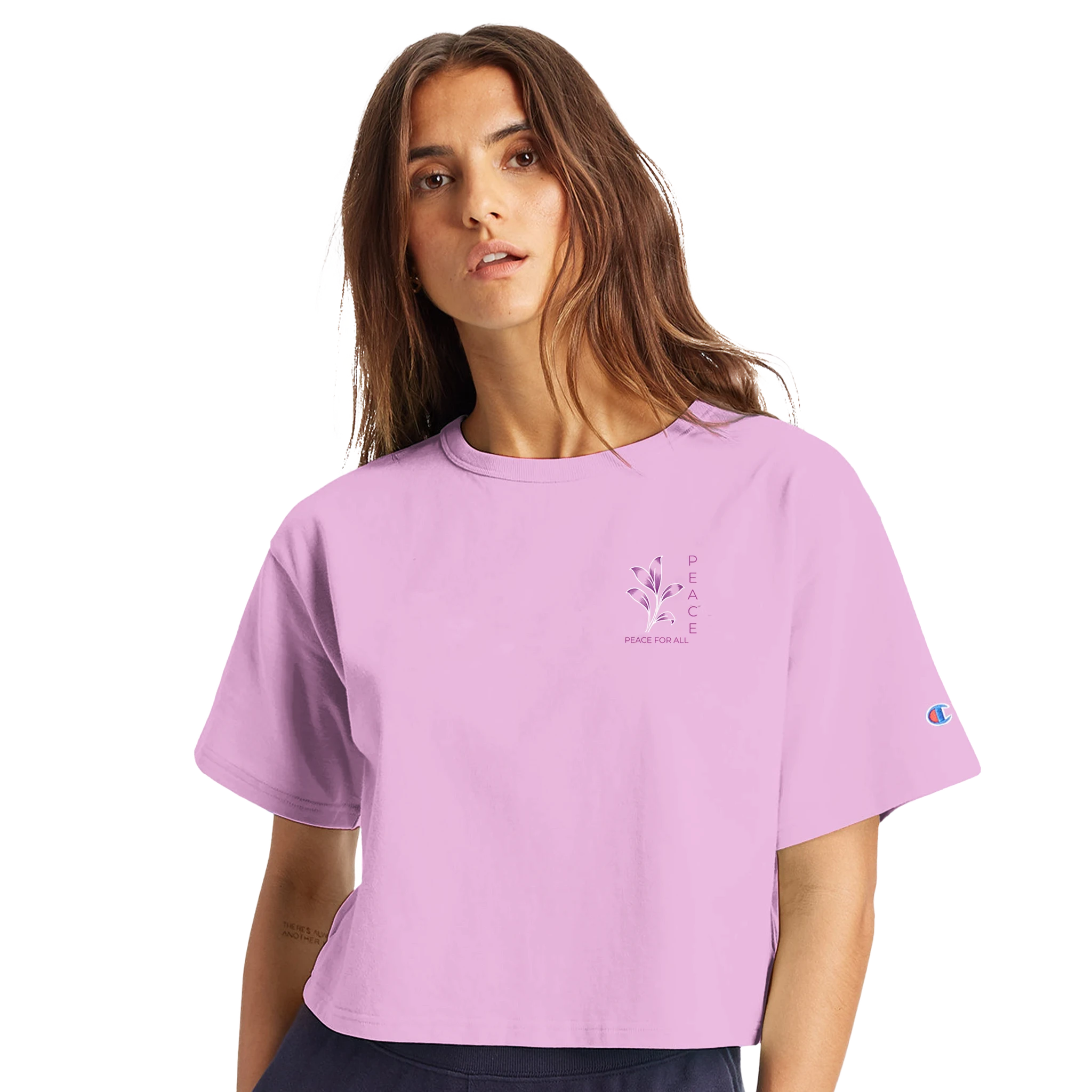 Women’s cropped heritage t-shirt in pastel pink, small chest graphic and sleeve Champion logo