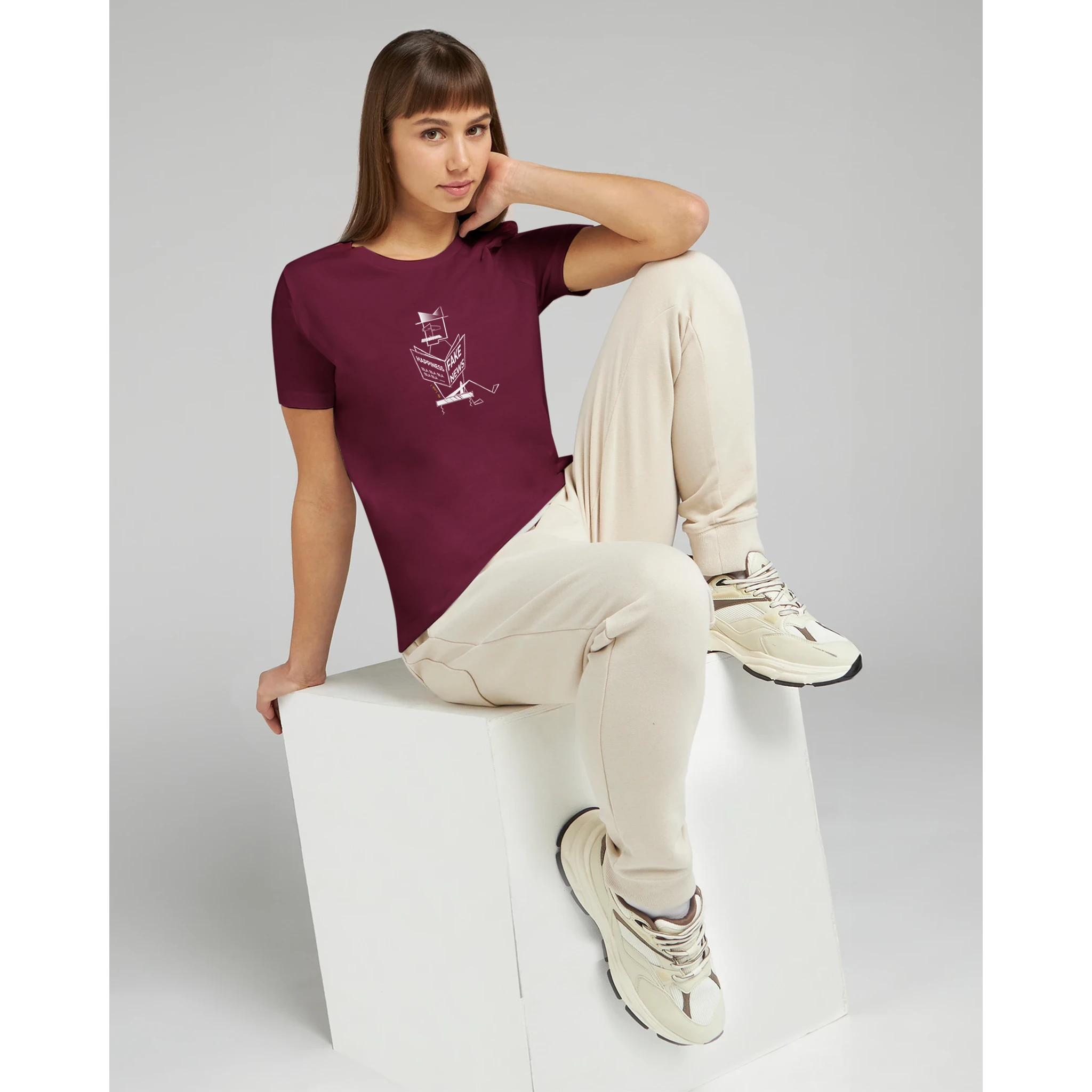 Maroon relaxed T-shirt worn by a woman, white graphic logo on chest