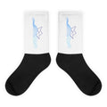 Pair of boat graphic crew socks: white ribbed leg, black foot, blue boat icon.