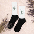 Peace socks pair with white ribbed fabric, black ankle cuff, green leaf peace print