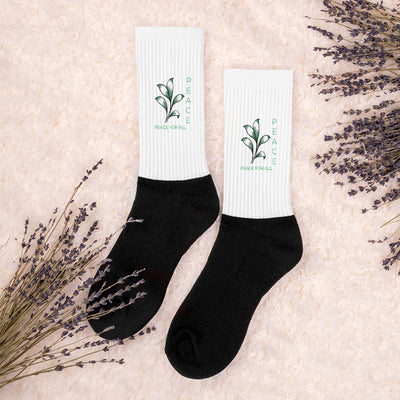 Peace socks pair with white ribbed fabric, black ankle cuff, green leaf peace print