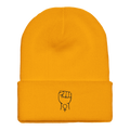 Cuffed beanie in gold with white fist icon on the cuff