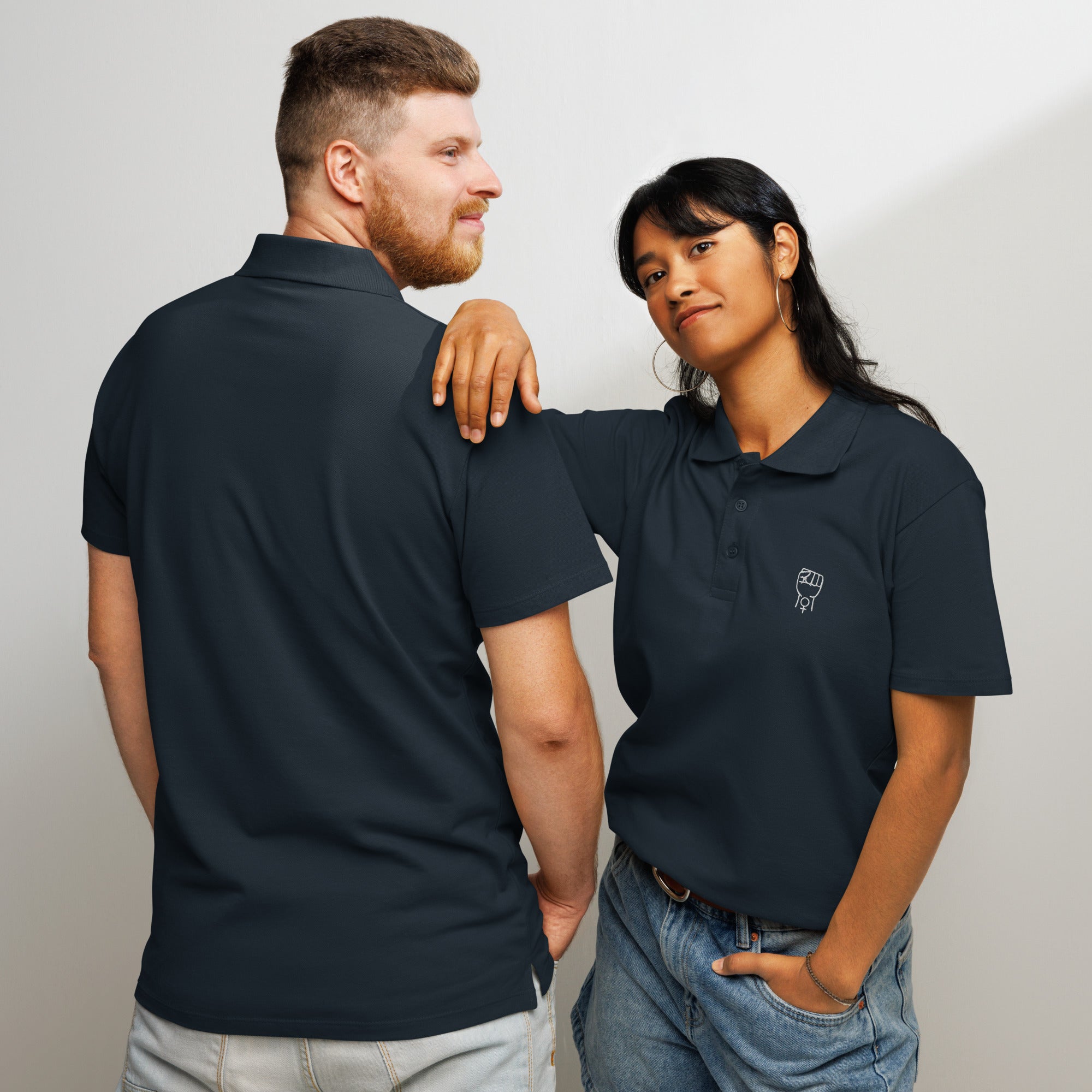 Navy polo shirt on model duo, short sleeves with buttoned collar and logo